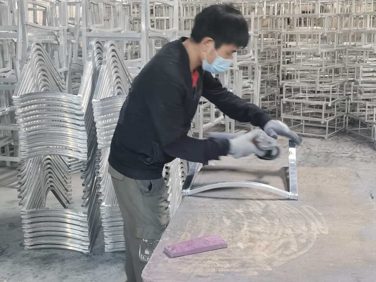 a worker is polishing aluminum frame Outdoor Furniture Supplier