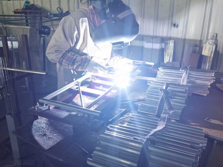 a worker is welding outdoor furniture Outdoor Furniture Supplier